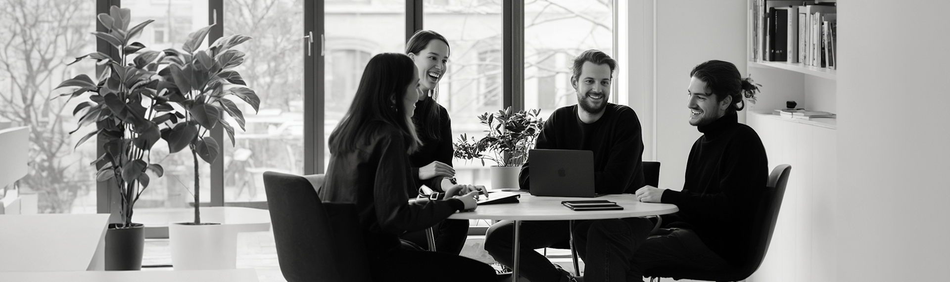 Gulzcom team talking around a table in a bright studio